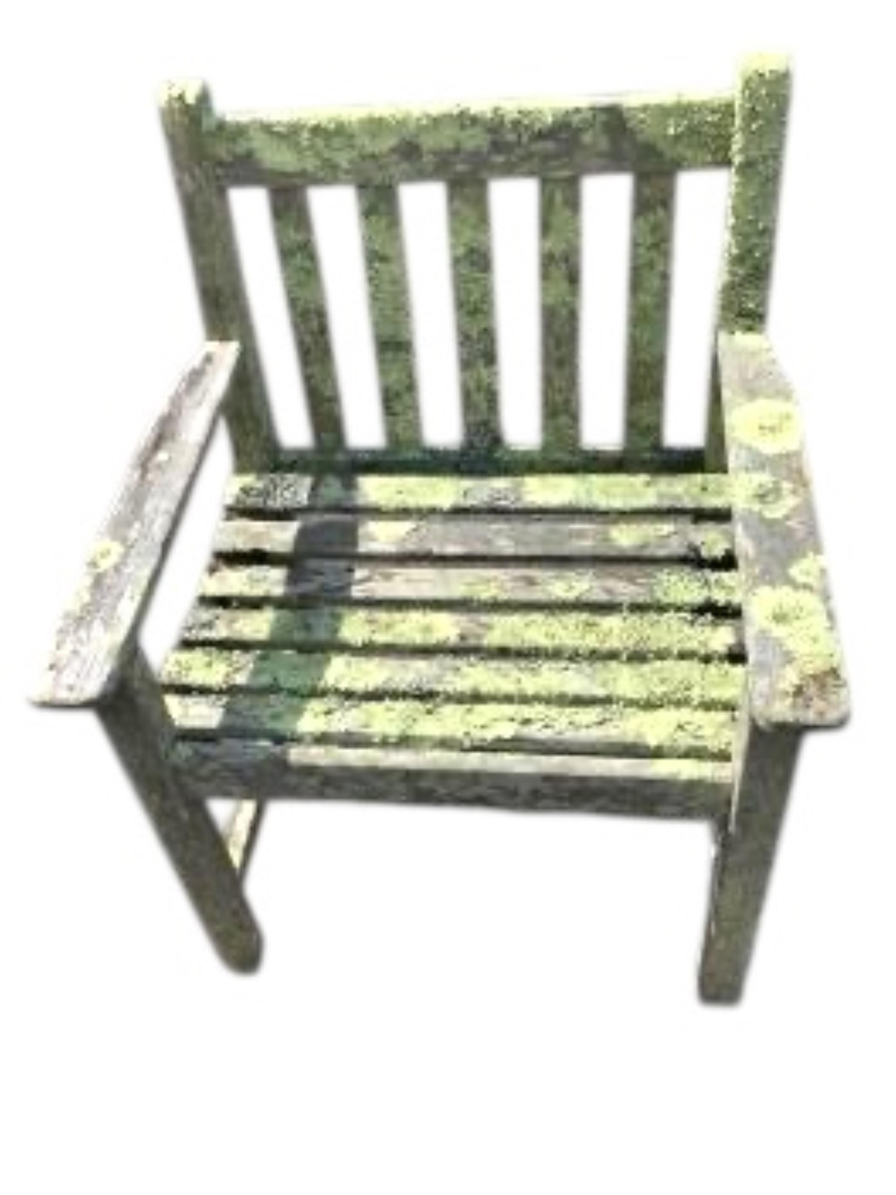 A weathered and lichen covered circular teak garden table, diameter 120cm, height 75cm and four armchairs